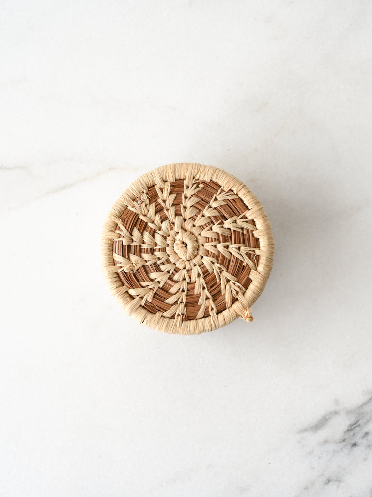 Woven basket on a white marble surface